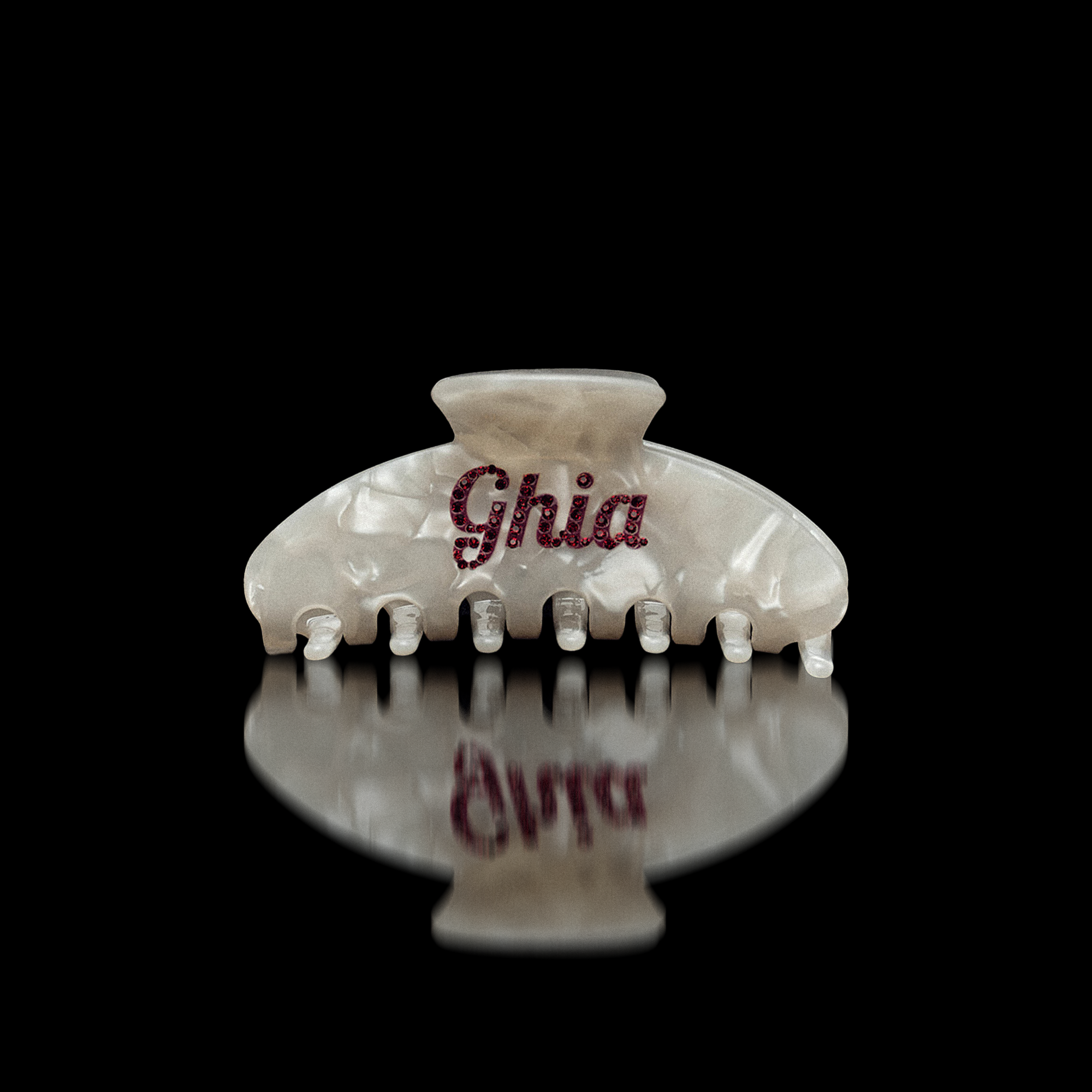 Pearlescent white Ciao Ghia claw hair clip with Ghia script in red rhinestones