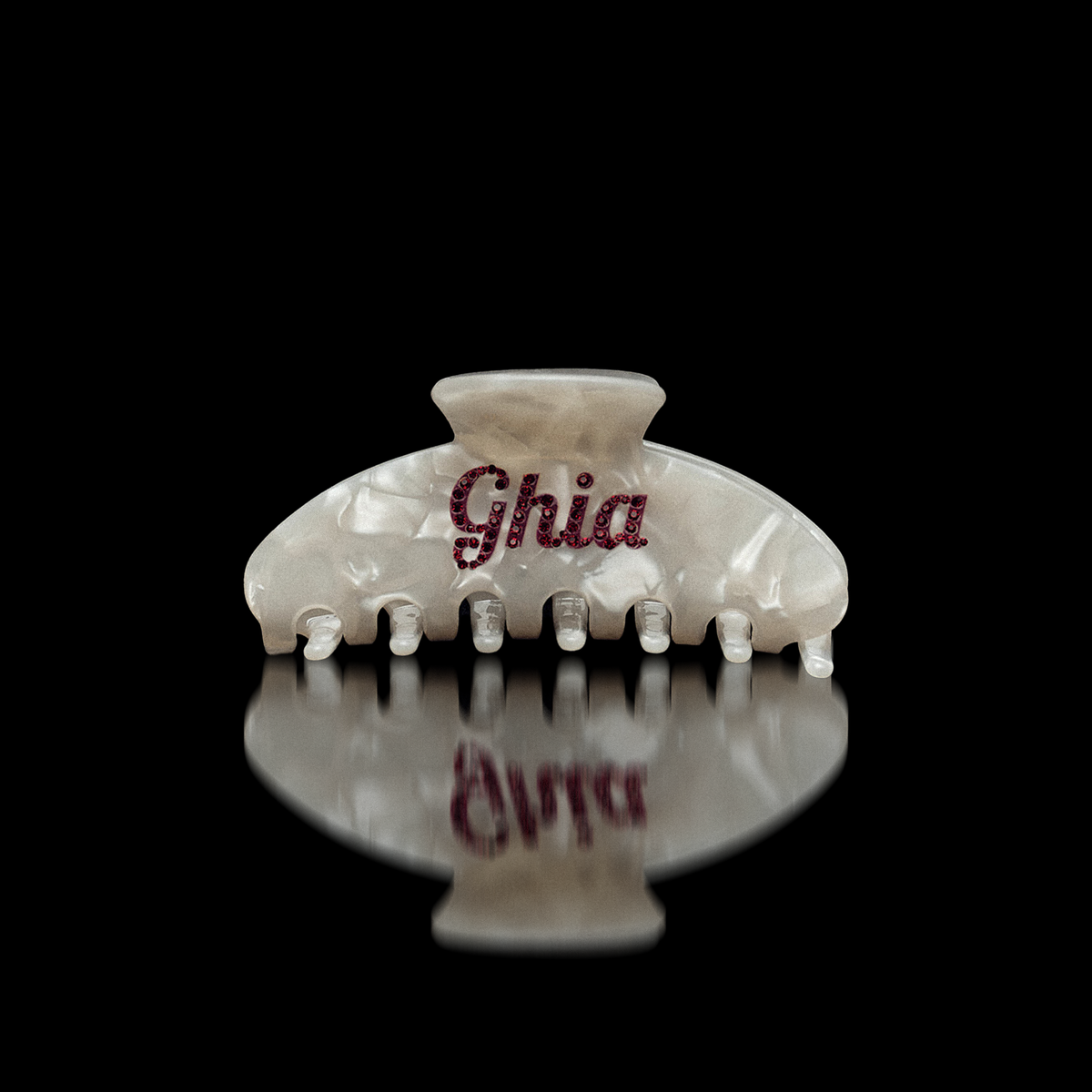 Pearlescent white Ciao Ghia claw hair clip with Ghia script in red rhinestones