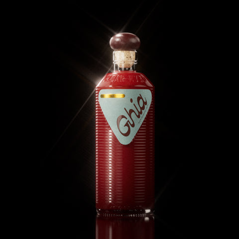 A Ghia non-alcoholic beverage in flavor Original Apéritif bottle with a deep red hue, ribbed glass design, a burgundy cork top, and a light blue label featuring bold branding.