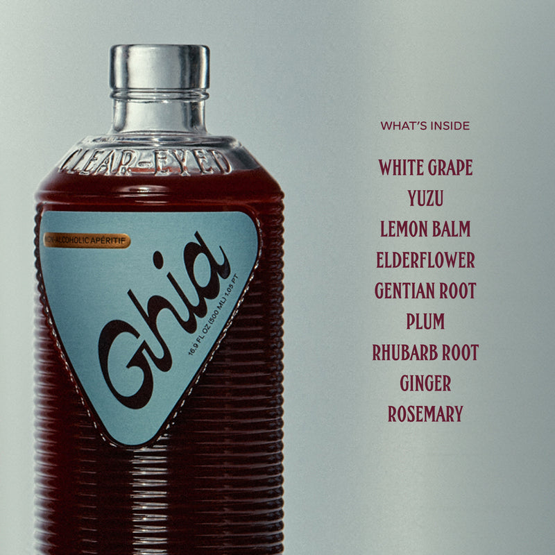 A bottle of Ghia non-alcoholic aperitif with a list of ingredients: white grape, yuzu, lemon balm, elderflower, gentian root, and more. The bottle has a blue label with the word "Ghia."
