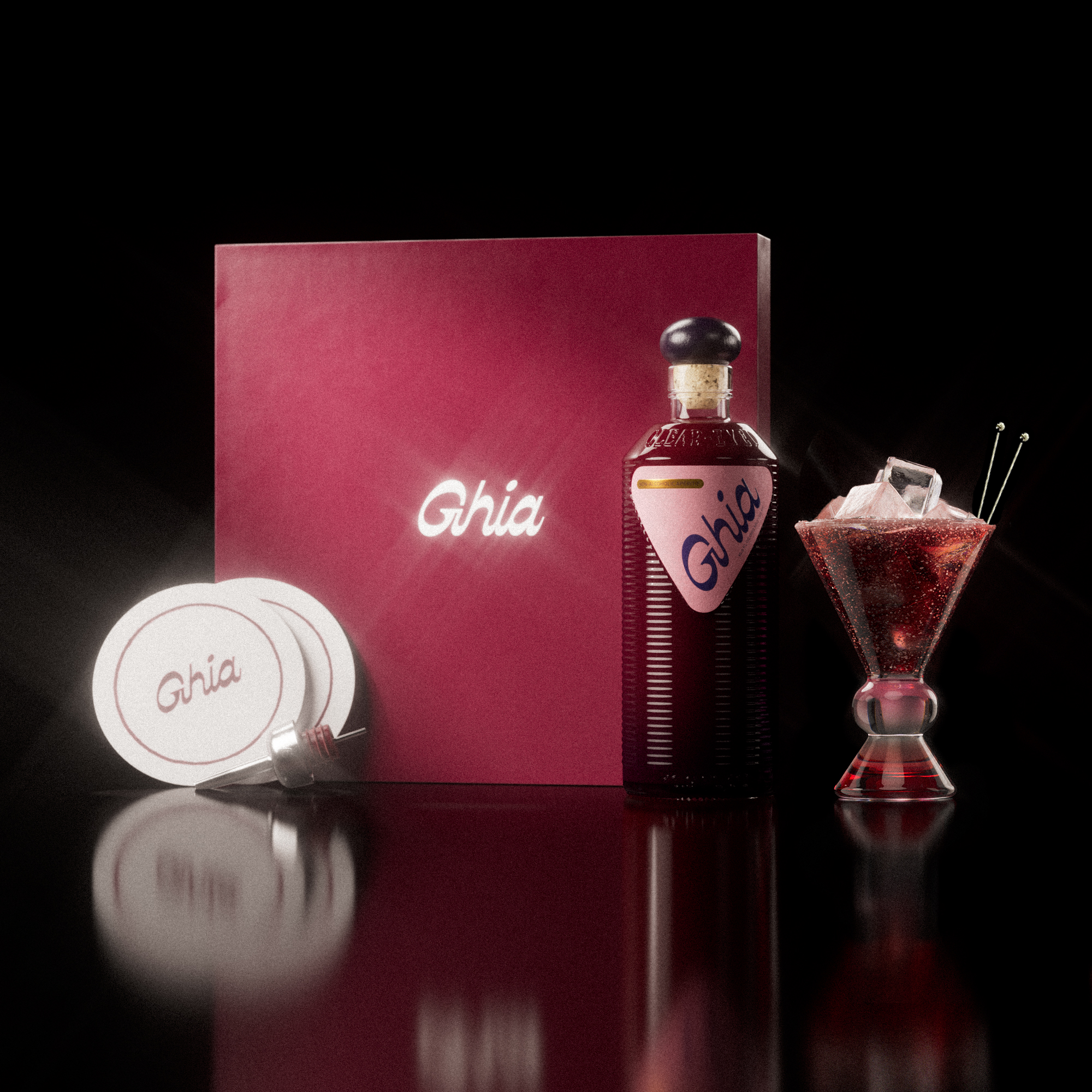 A Ghia non-alcoholic aperitif gift set with a burgundy box, paper coasters, 1 glass bottle of Berry Apéritif, and a decorative cocktail glass that has a pink and amber base.