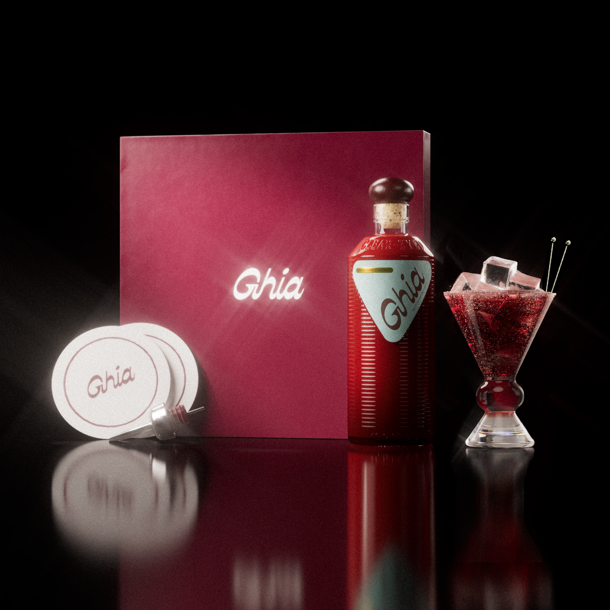 A Ghia non-alcoholic aperitif gift set with a burgundy box, paper coasters, 1 glass bottle of Original Apéritif, and a decorative cocktail glass that has a amber and clear base.