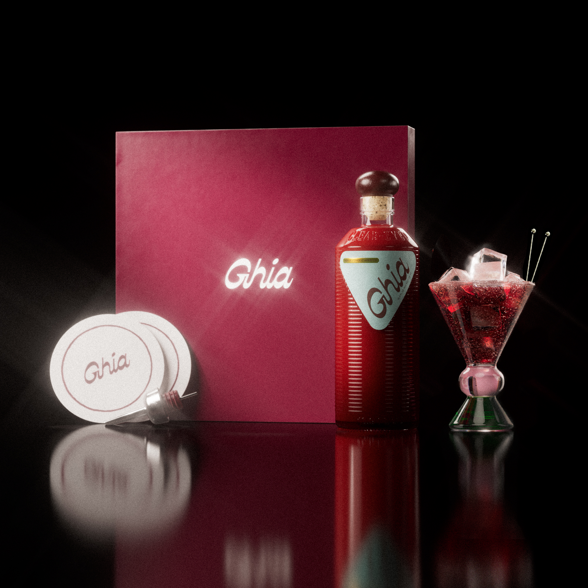 A Ghia non-alcoholic aperitif gift set with a burgundy box, paper coasters, 1 glass bottle of Original Apéritif, and a decorative cocktail glass that has a pink and green base.