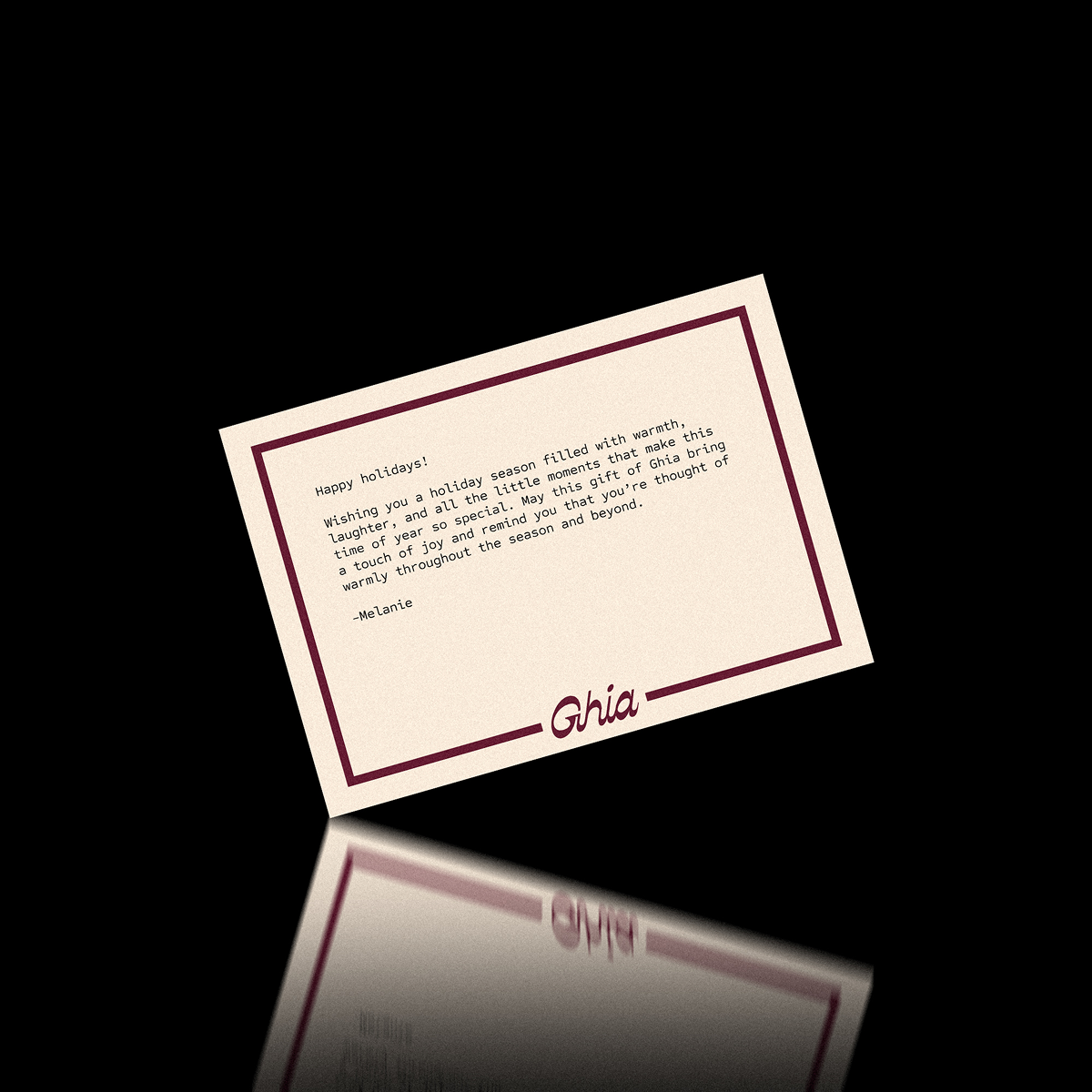 Cream Ghia gift note card with typed holiday message wishing a season filled with warmth and laughter