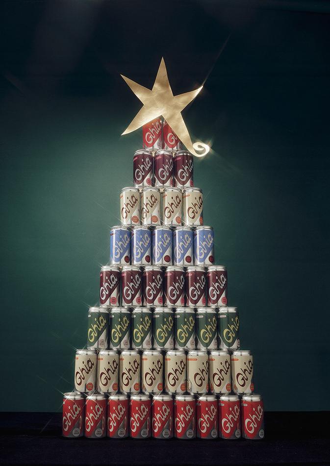 Holiday tree built from stacked Ghia Le Spritz cans topped with a gold star